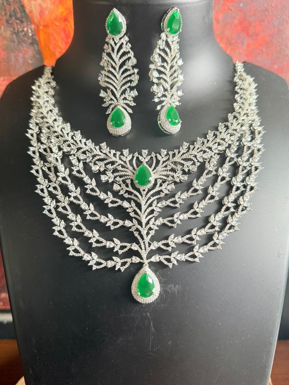 Jewelry set with necklace and earrings on a black stand