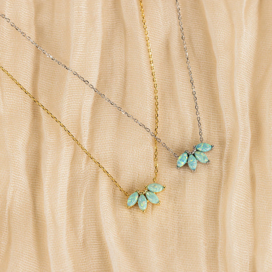 Modern luxury gold and gemstone jewellery styled on neutral fabric in soft natural light