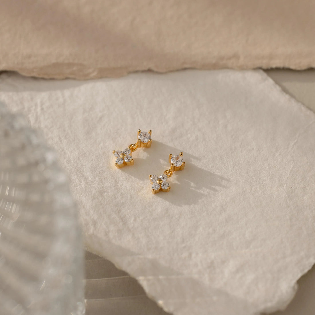 Minimal daytime jewellery styled beside bold evening statement earrings in contrasting natural and warm lighting