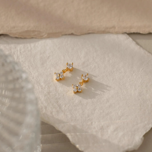 Minimal daytime jewellery styled beside bold evening statement earrings in contrasting natural and warm lighting