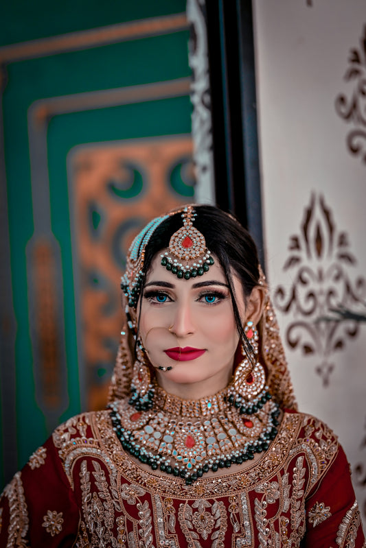 A woman in a red and gold bridal outfit