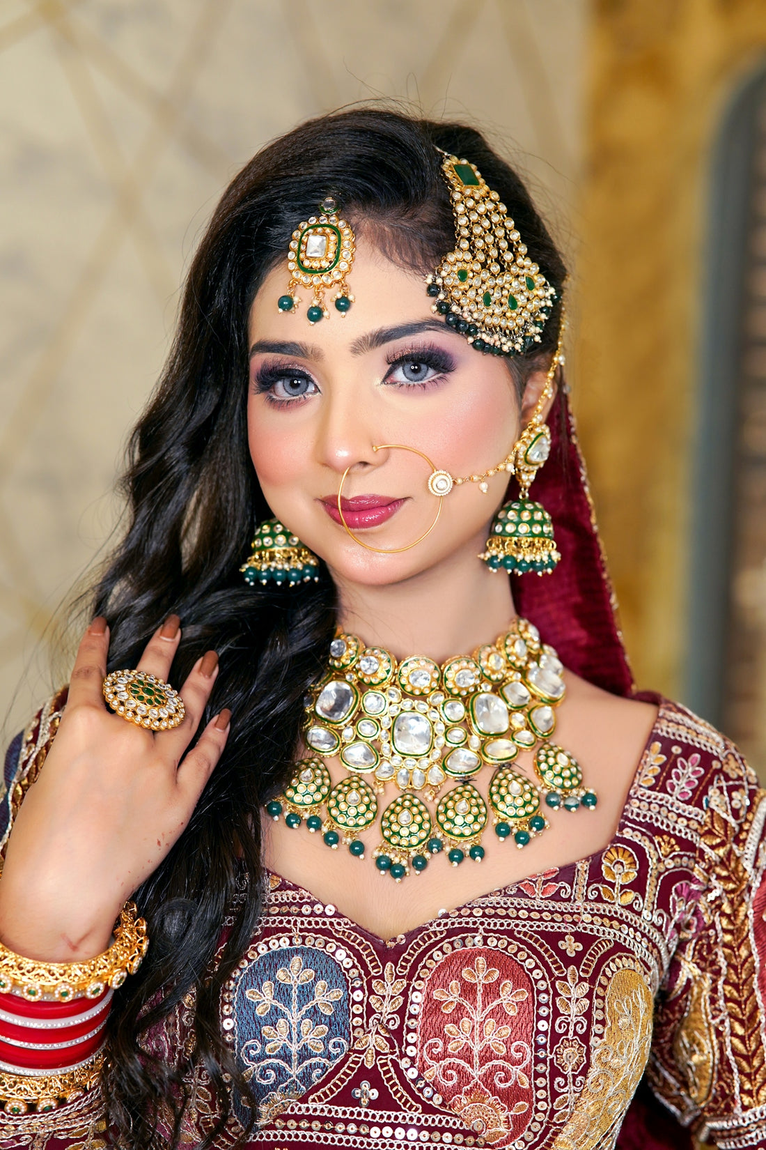 A woman in a red and gold bridal outfit