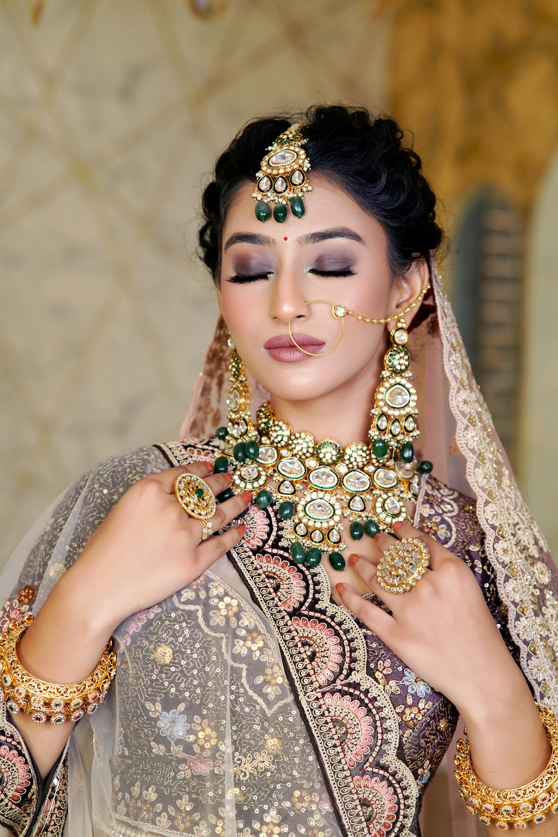 A woman wearing a bridal outfit and jewelry