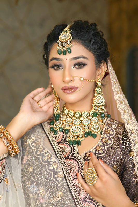 A woman wearing a bridal outfit and jewelry