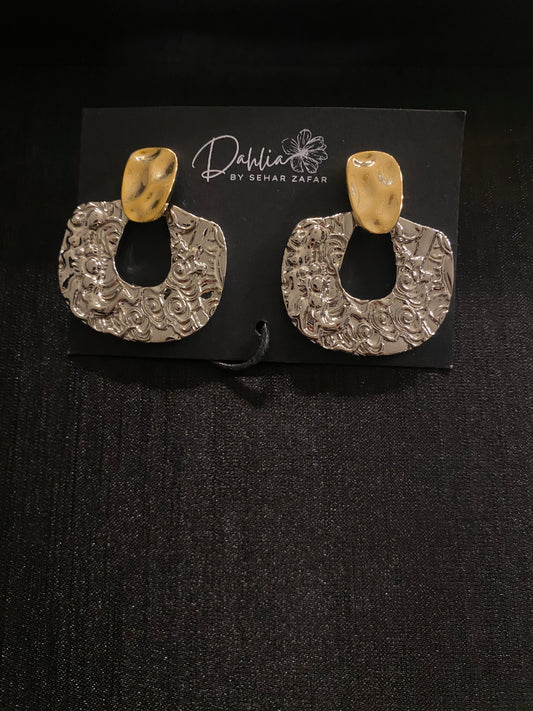 Gold and silver textured statement hoop earrings on black display card