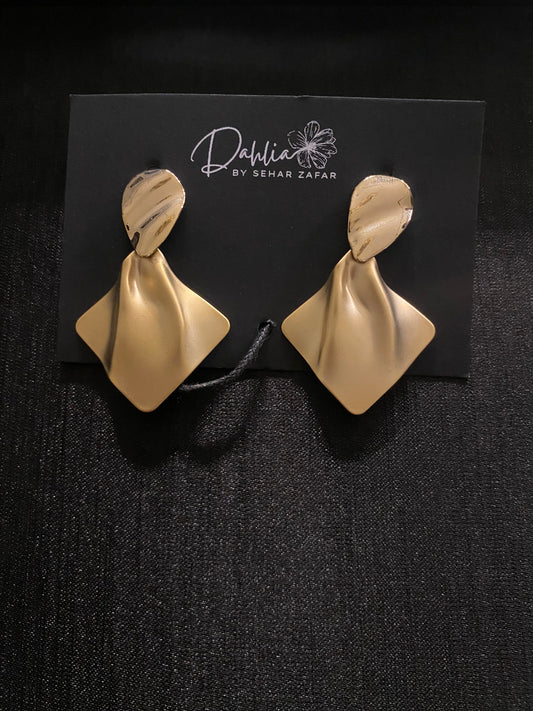 Gold folded earrings with marbled oval tops on black branded card