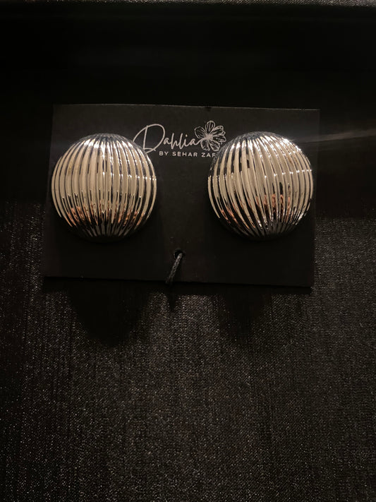 Silver ribbed dome earrings with vertical grooves on black branded card