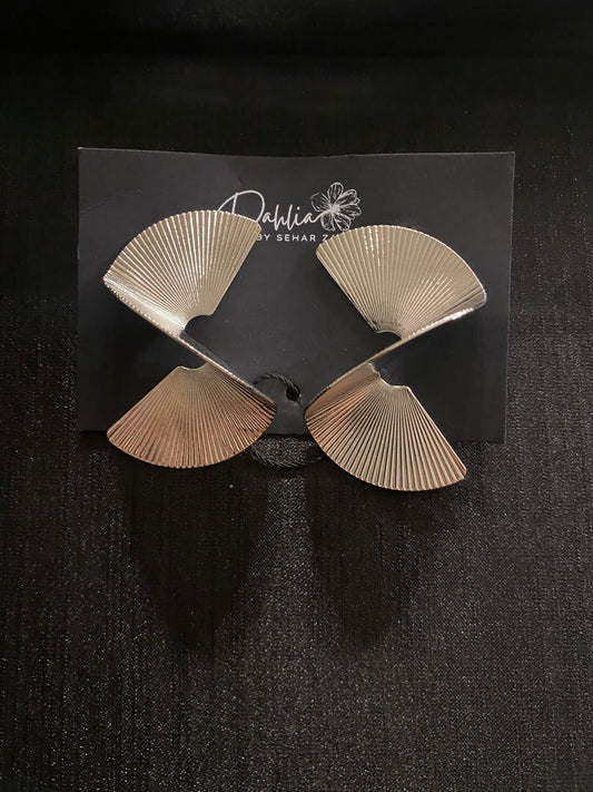 Fan-shaped metallic earrings with ridged texture on black branded card