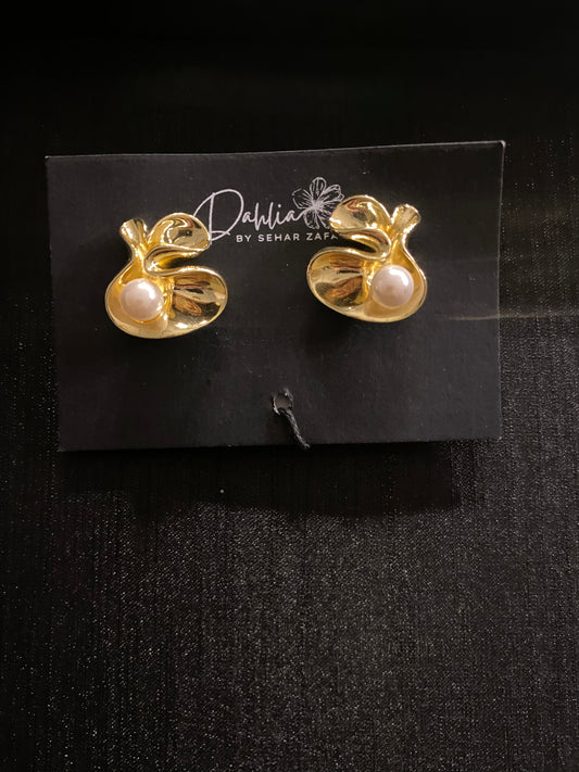 Gold abstract floral earrings with pearl accent on black branded card
