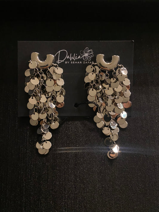 Gold cascading disc earrings with curved top accent on black branded card