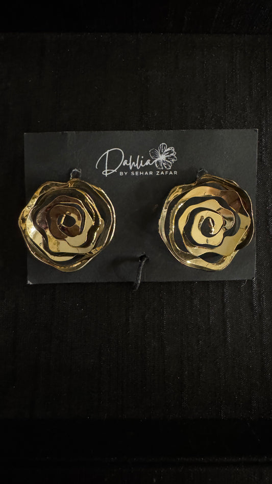 Gold abstract rose earrings with layered spiral petals on black branded card