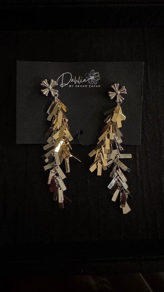 Gold and silver cascading earrings with floral stud and geometric drops on black branded card