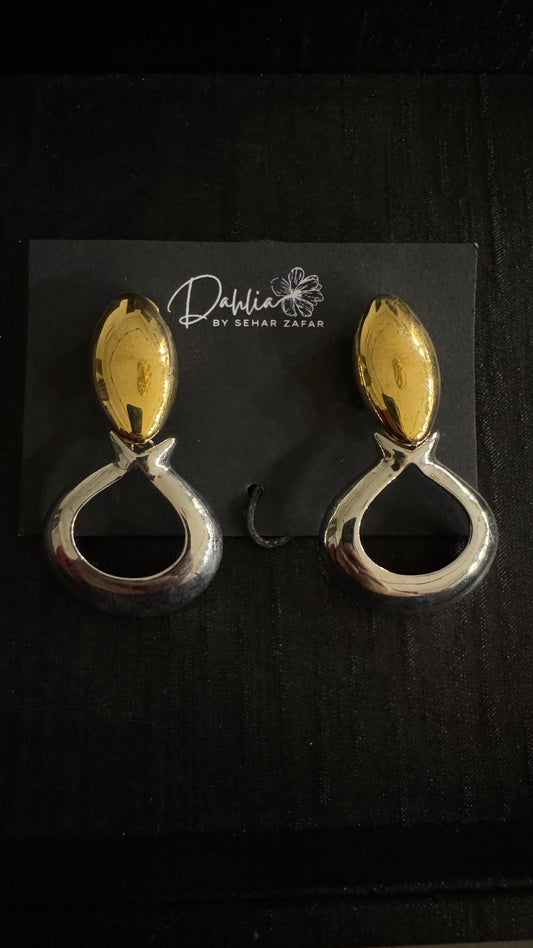 Gold and silver teardrop earrings with oval stud accent on black branded card