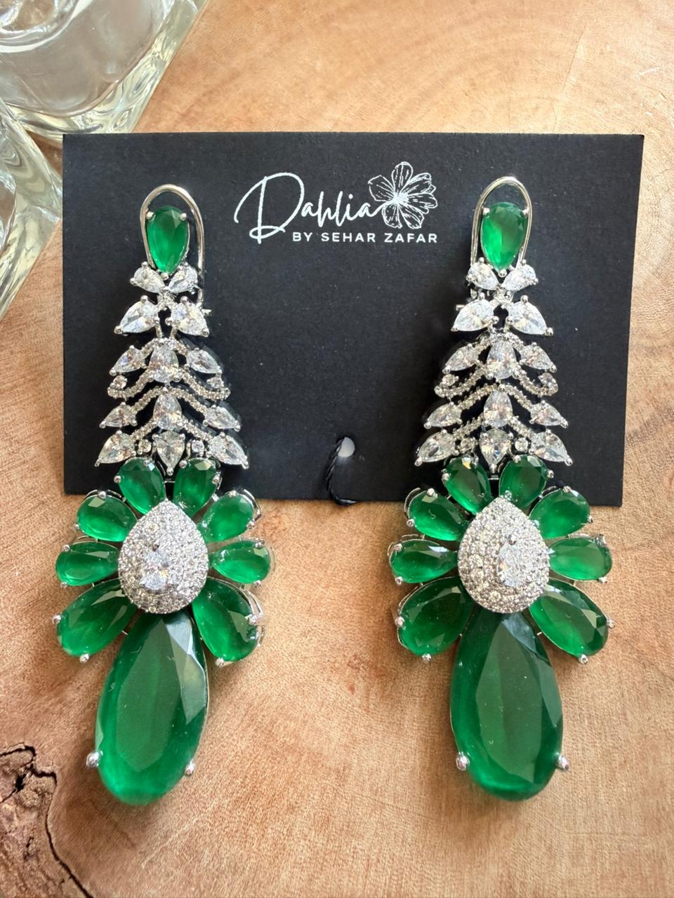 Emerald floral statement drop earrings with crystal detailing and large green teardrop stones.