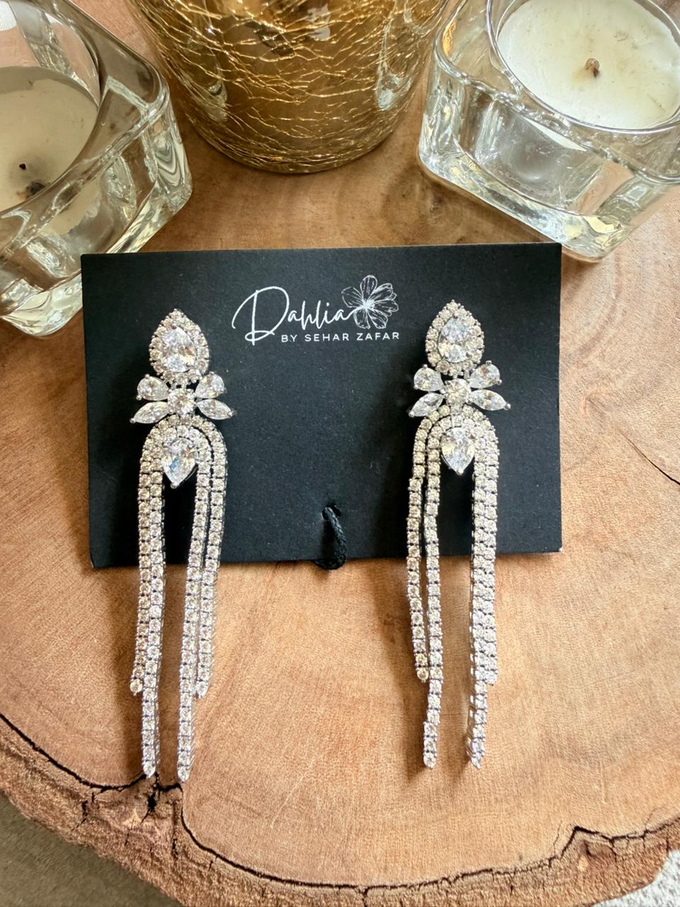 Crystal waterfall drop earrings with cascading multi-row diamond strands.