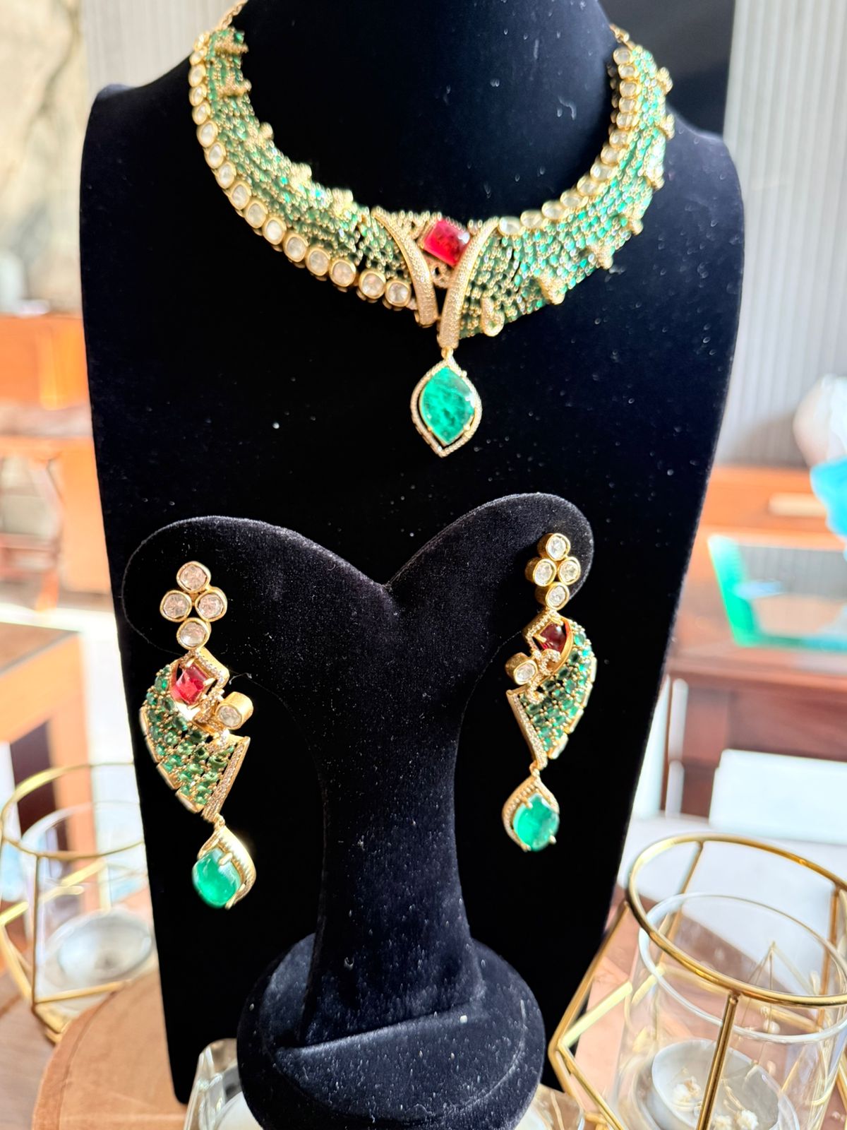 Jewelry set with necklace and earrings on a black stand