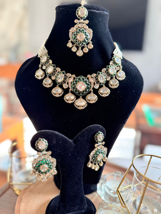 Jewelry set with necklace and earrings on a black velvet stand.