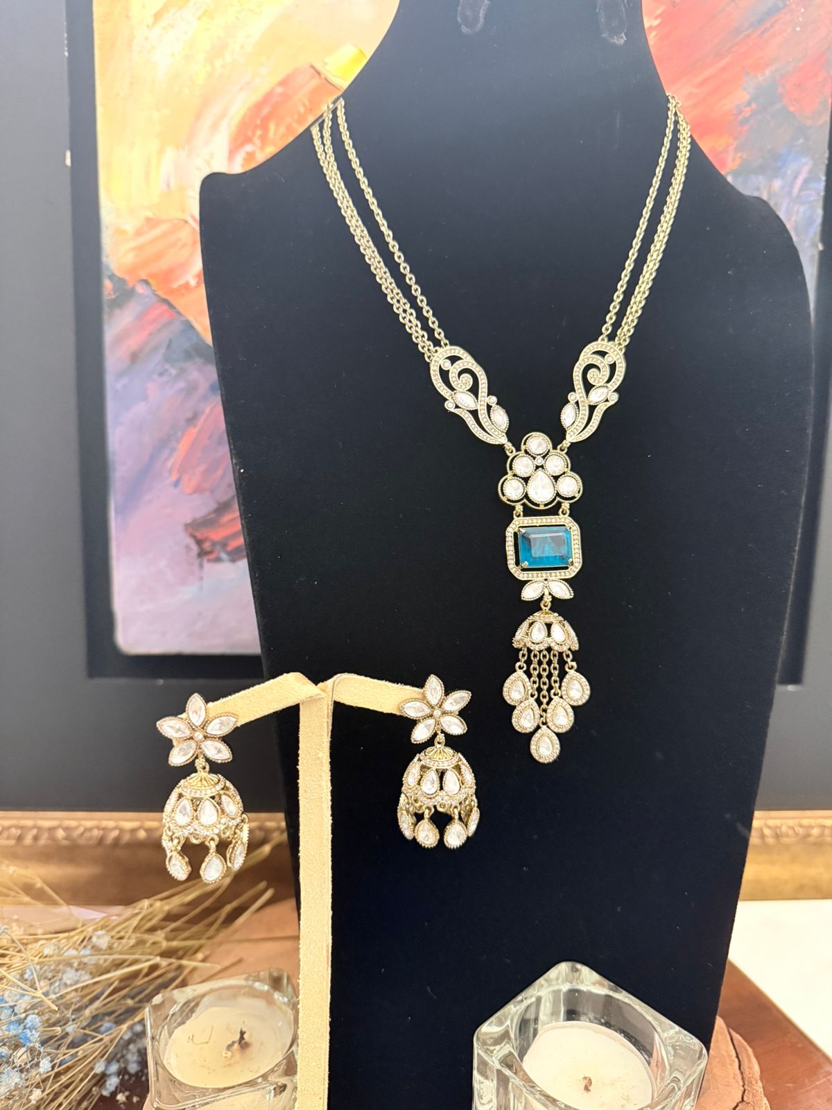 Emerald long necklace set with crystal detailing and matching jhumka earrings in gold finish