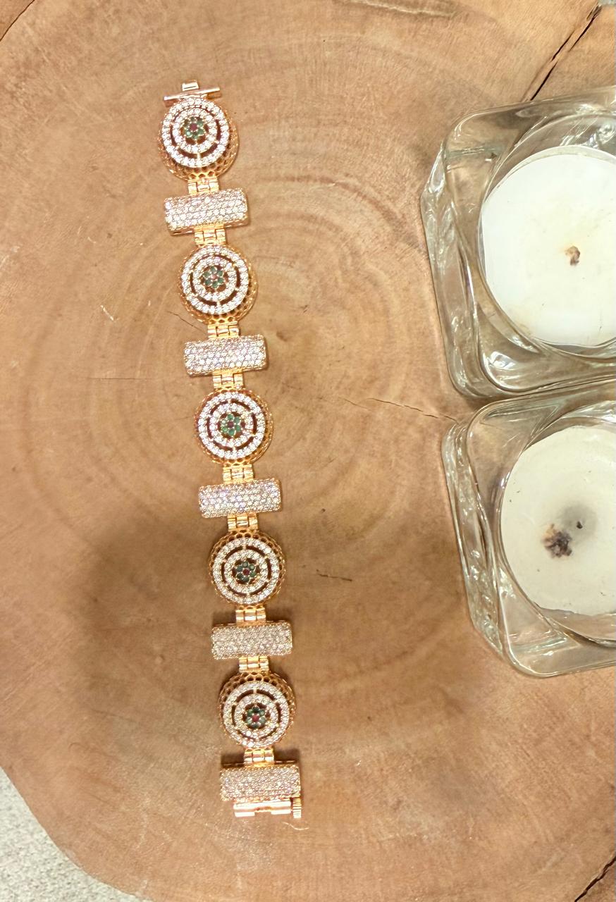 Gold and diamond bracelet on a wooden surface with candles in the background