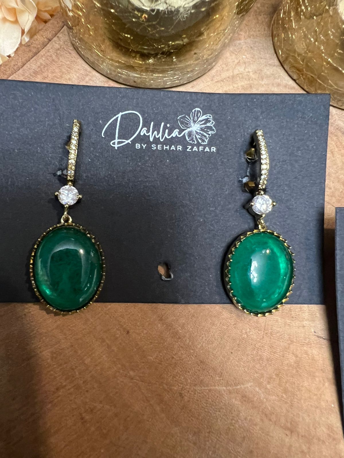 Green earrings on a branded card with 'Dahlia by Sehar Zafar' logo.