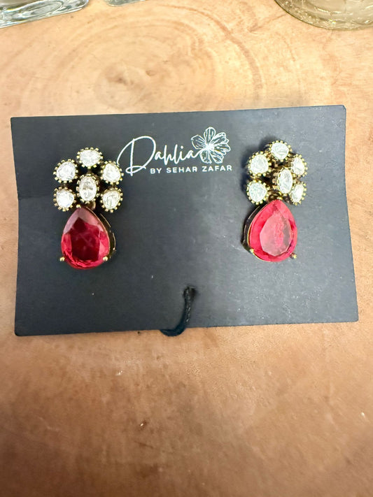 Red teardrop earrings with gold accents on a black card with 'Dahlia by Sehar Zafar' branding.